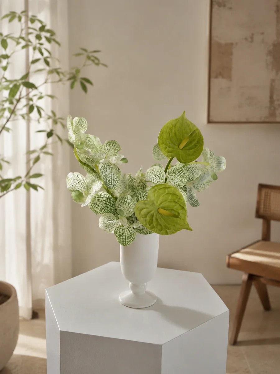 Compact green and white artificial orchid and anthurium arrangement in a white ceramic vessel, PO001