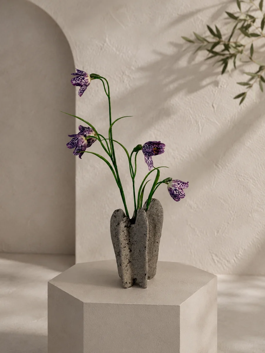 Purple artificial fritillaria flowers in a textured sculptural ceramic vessel, PO004