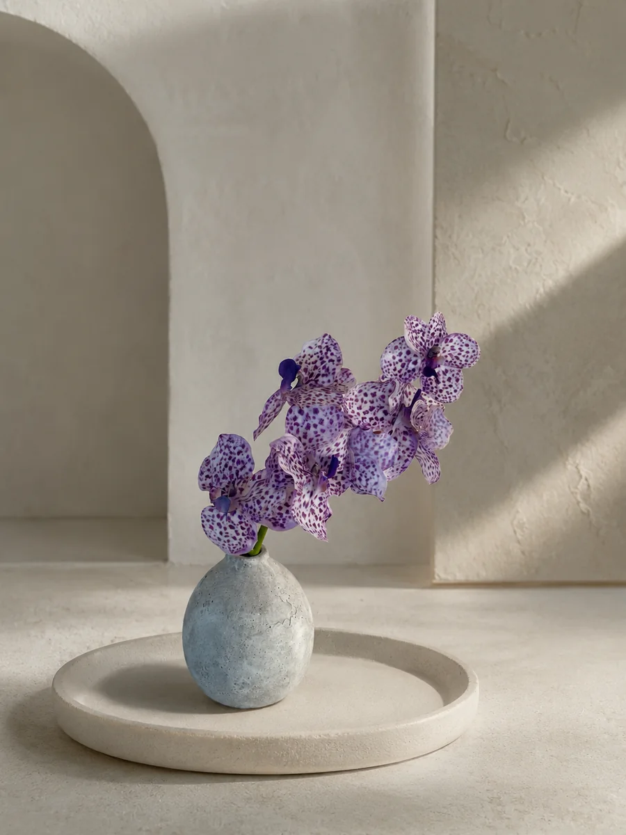 Purple spotted artificial orchid arrangement in a small ceramic vessel, PO005
