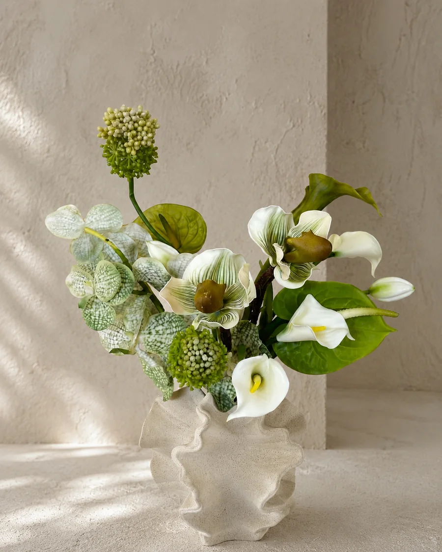Layered green and white artificial botanical arrangement in a sculptural ceramic vessel, PO008