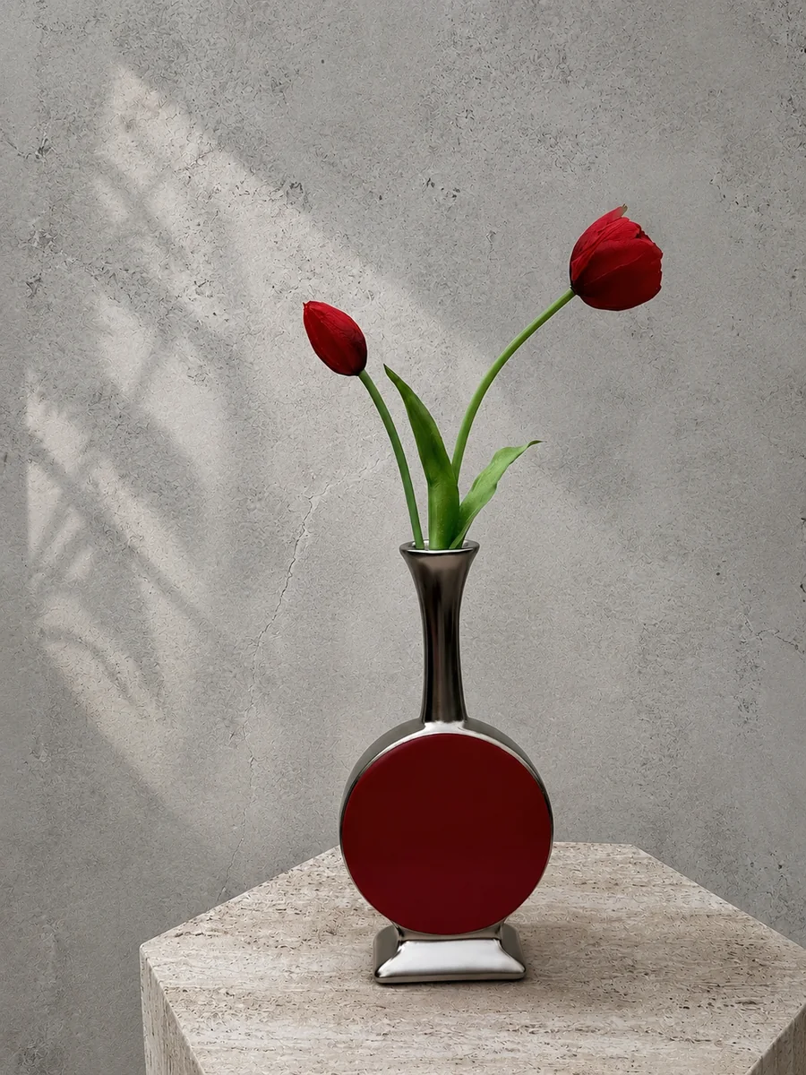Two red artificial tulips in a handcrafted red drum-inspired vessel, PO011